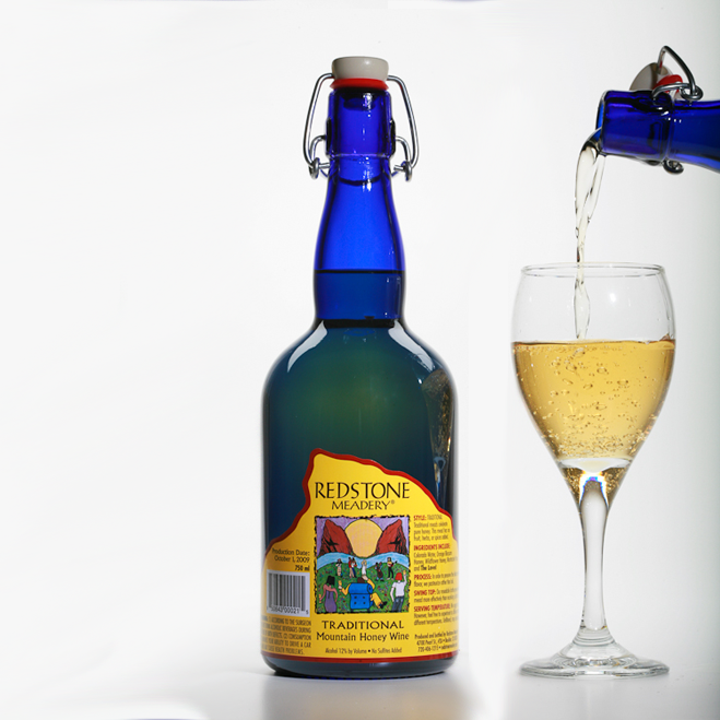 Bottle of mead and mead being poured into a wine glass