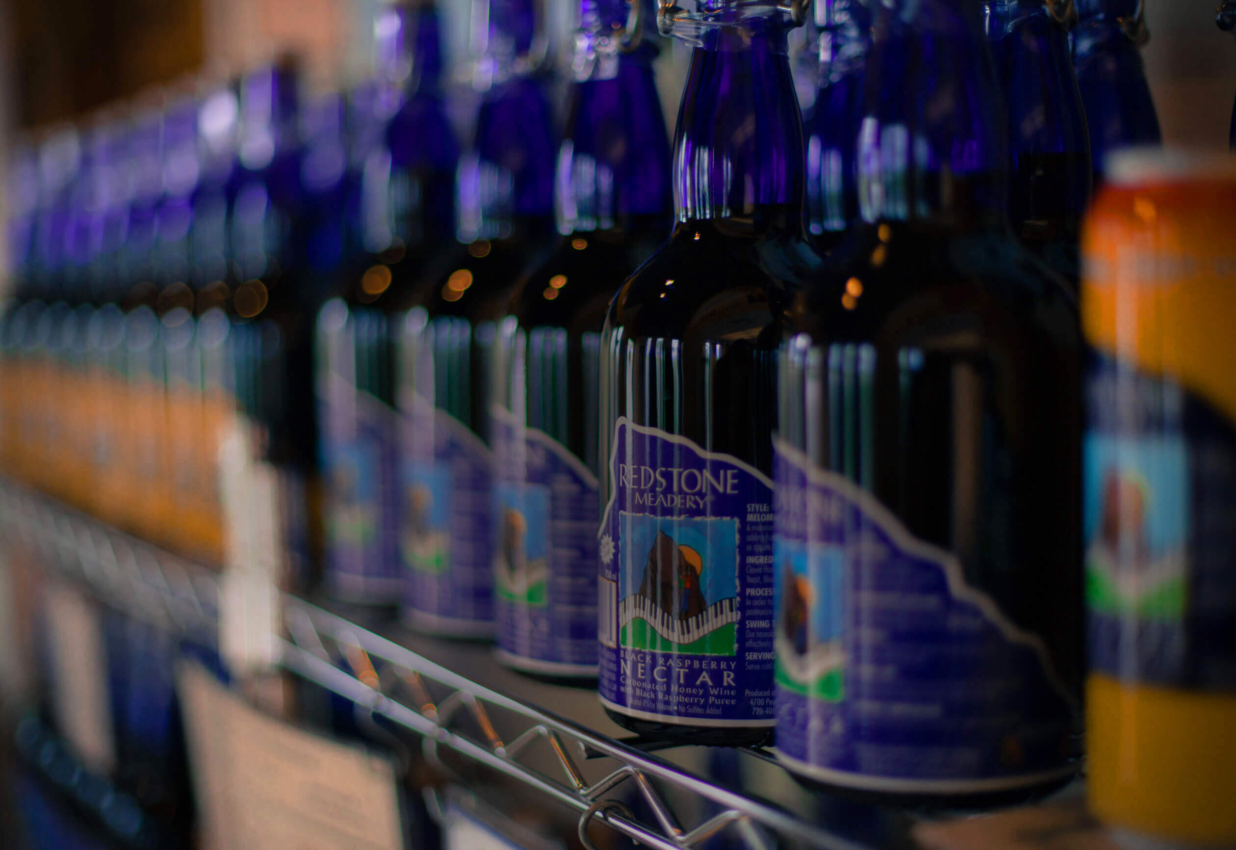 Blue bottles of mead on a shelf